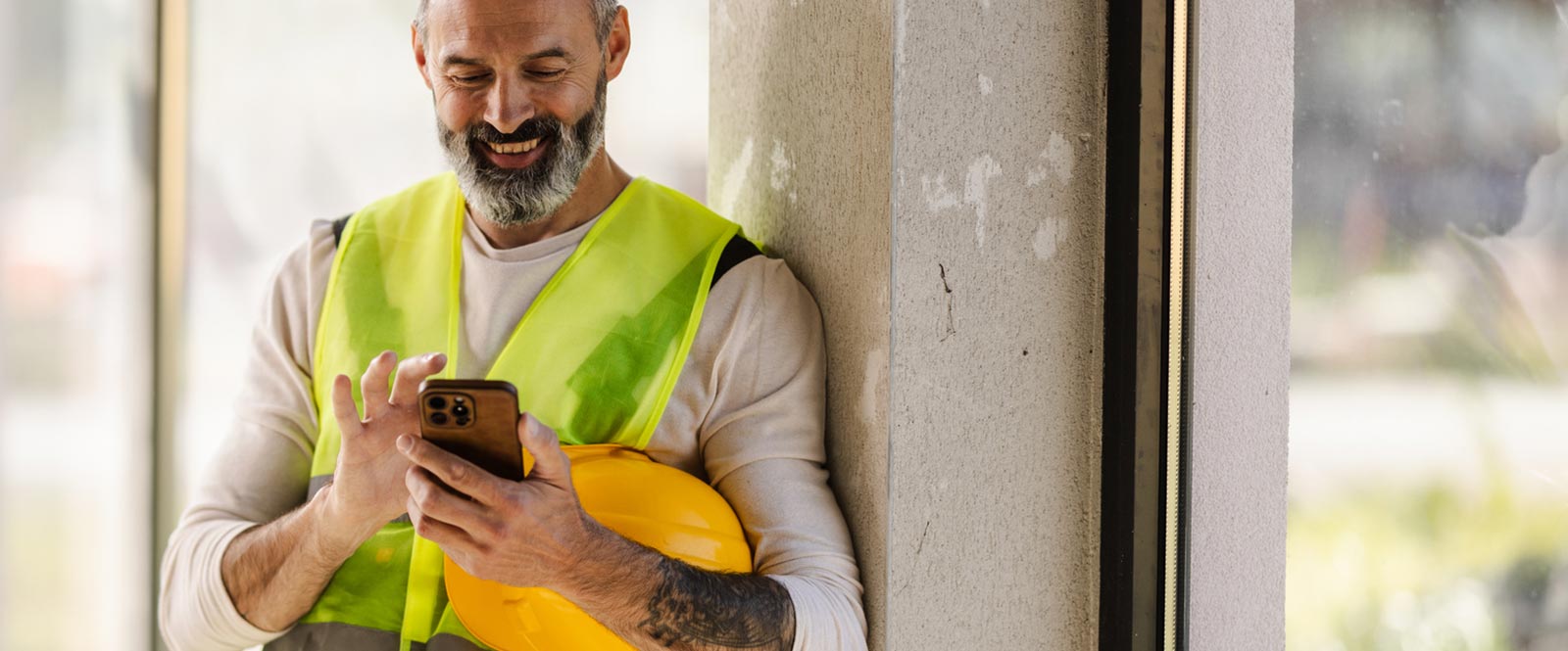Contractor using his smartphone on a job site
