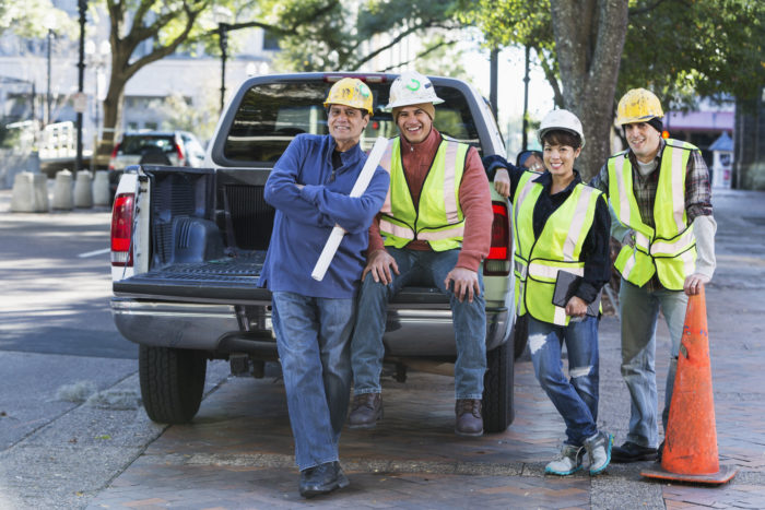 Construction workers by a pickup truck